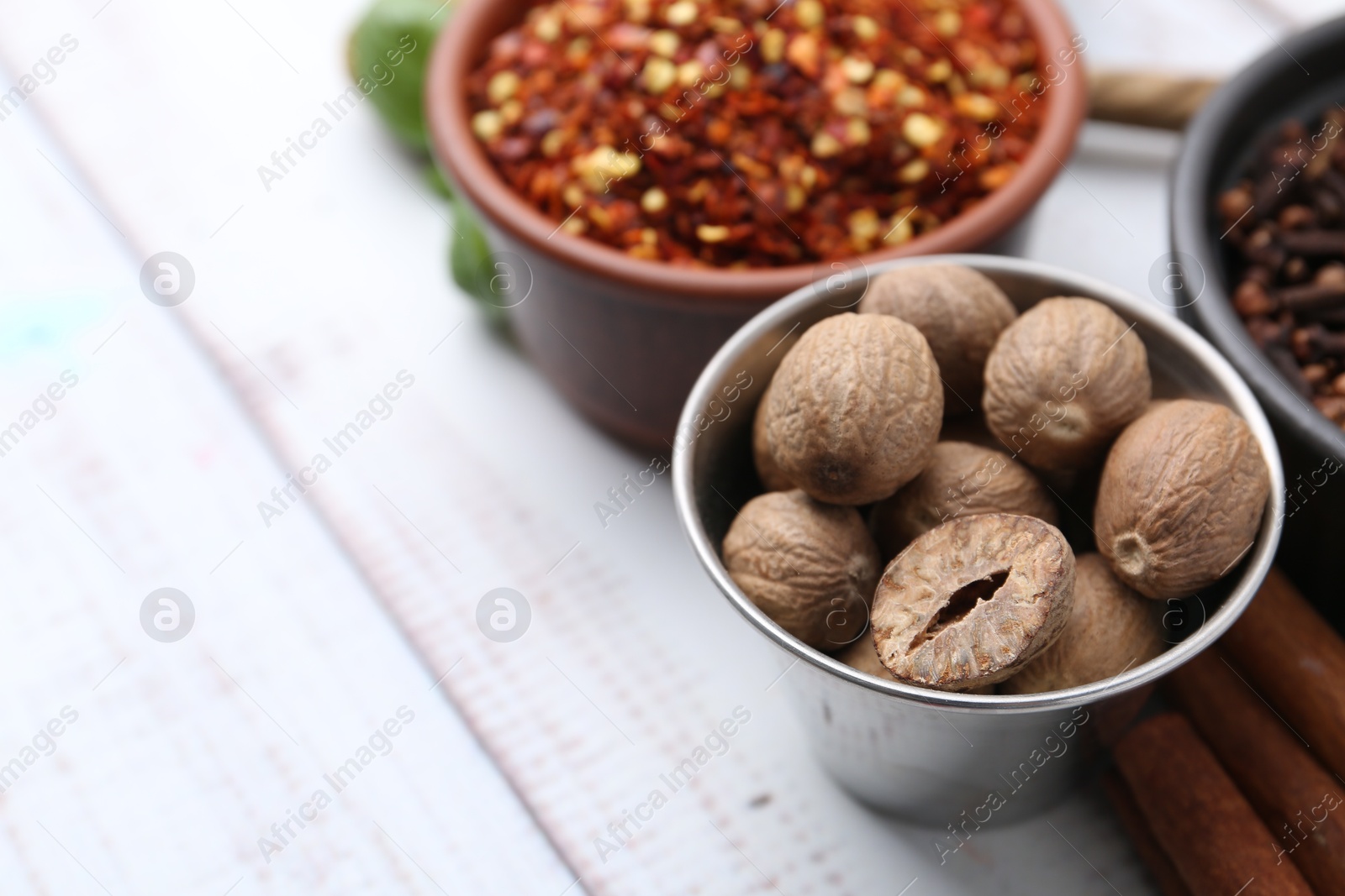 Different aromatic spices on white wooden table, closeup. Space for text Photo of Different aromatic spices on white wooden table, closeup. Space for text