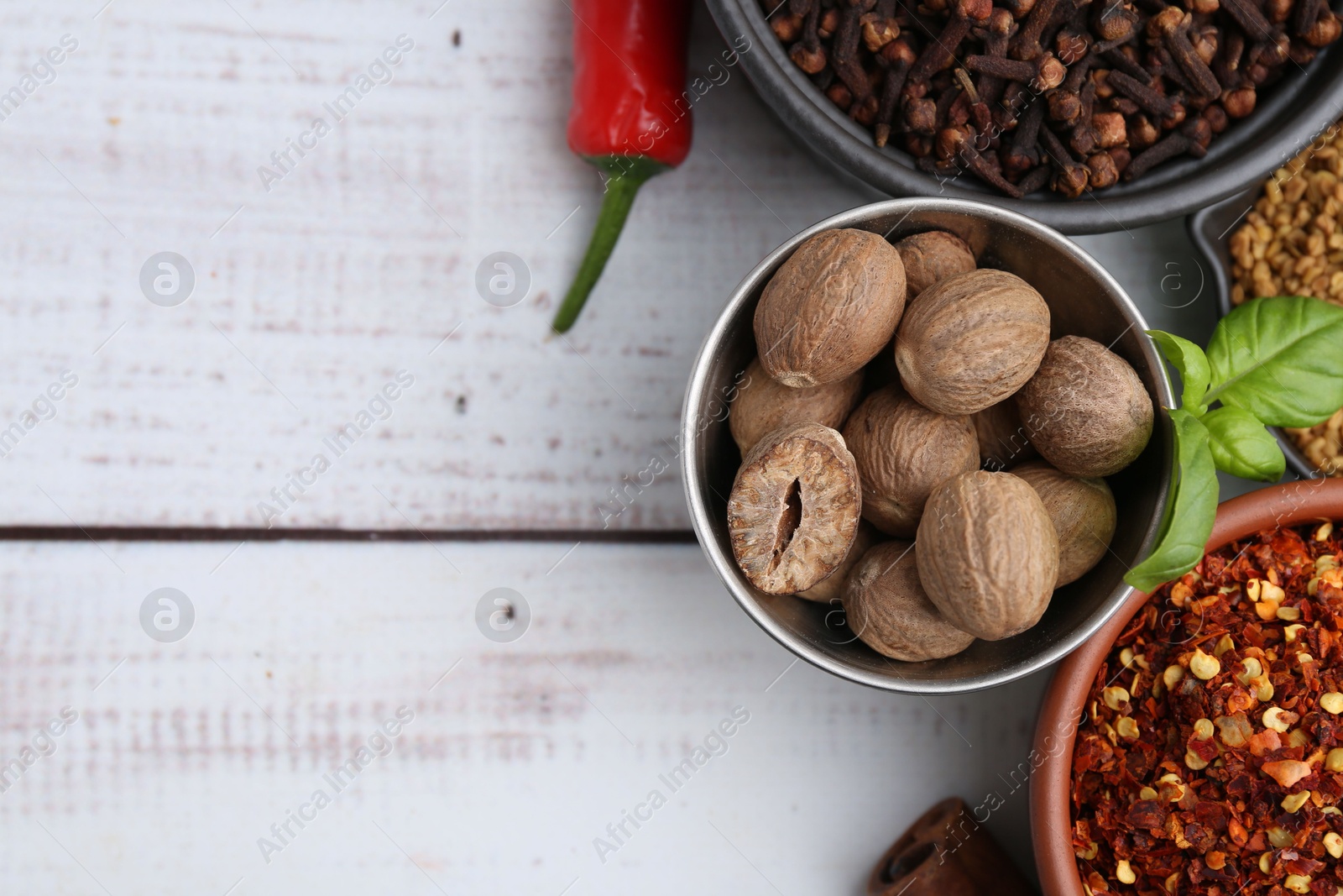 Different aromatic spices on white wooden table, flat lay. Space for text Photo of Different aromatic spices on white wooden table, flat lay. Space for text