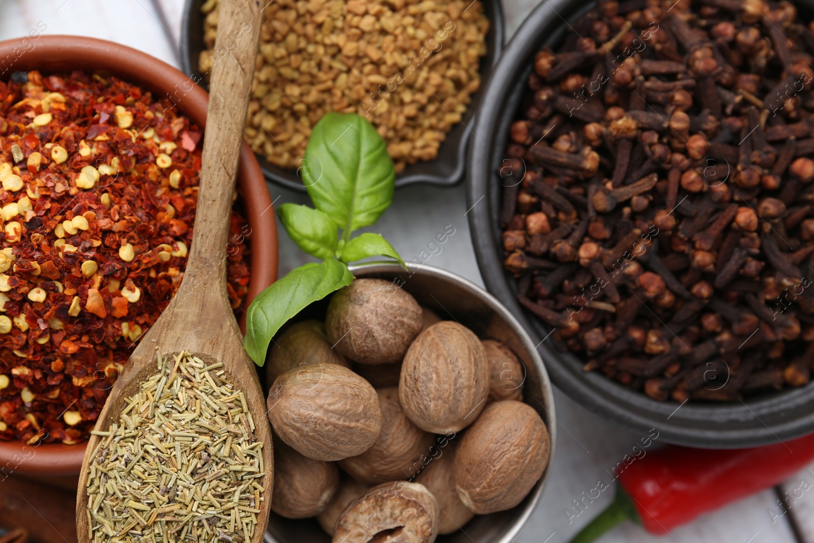 Different aromatic spices on white wooden table, closeup Photo of Different aromatic spices on white wooden table, closeup