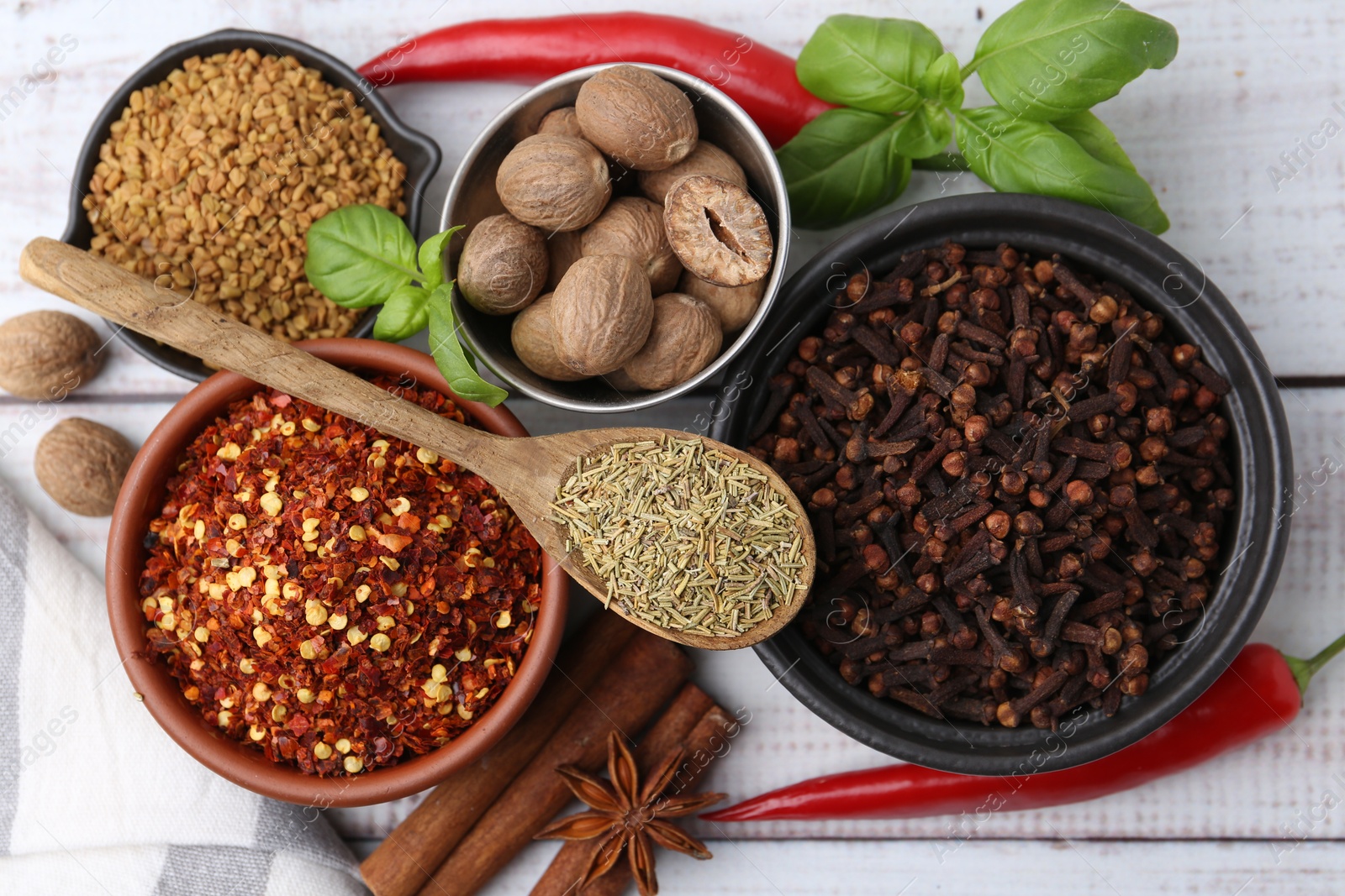 Different aromatic spices on white wooden table, flat lay Photo of Different aromatic spices on white wooden table, flat lay