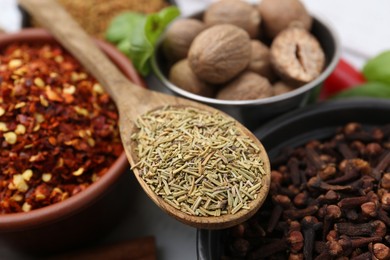 Photo of Different aromatic spices on white table, closeup