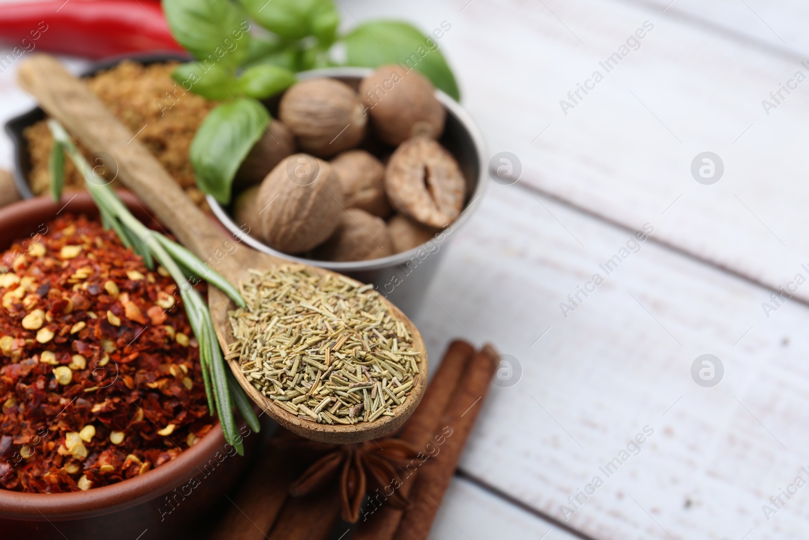 Different aromatic spices on white wooden table, closeup. Space for text Photo of Different aromatic spices on white wooden table, closeup. Space for text