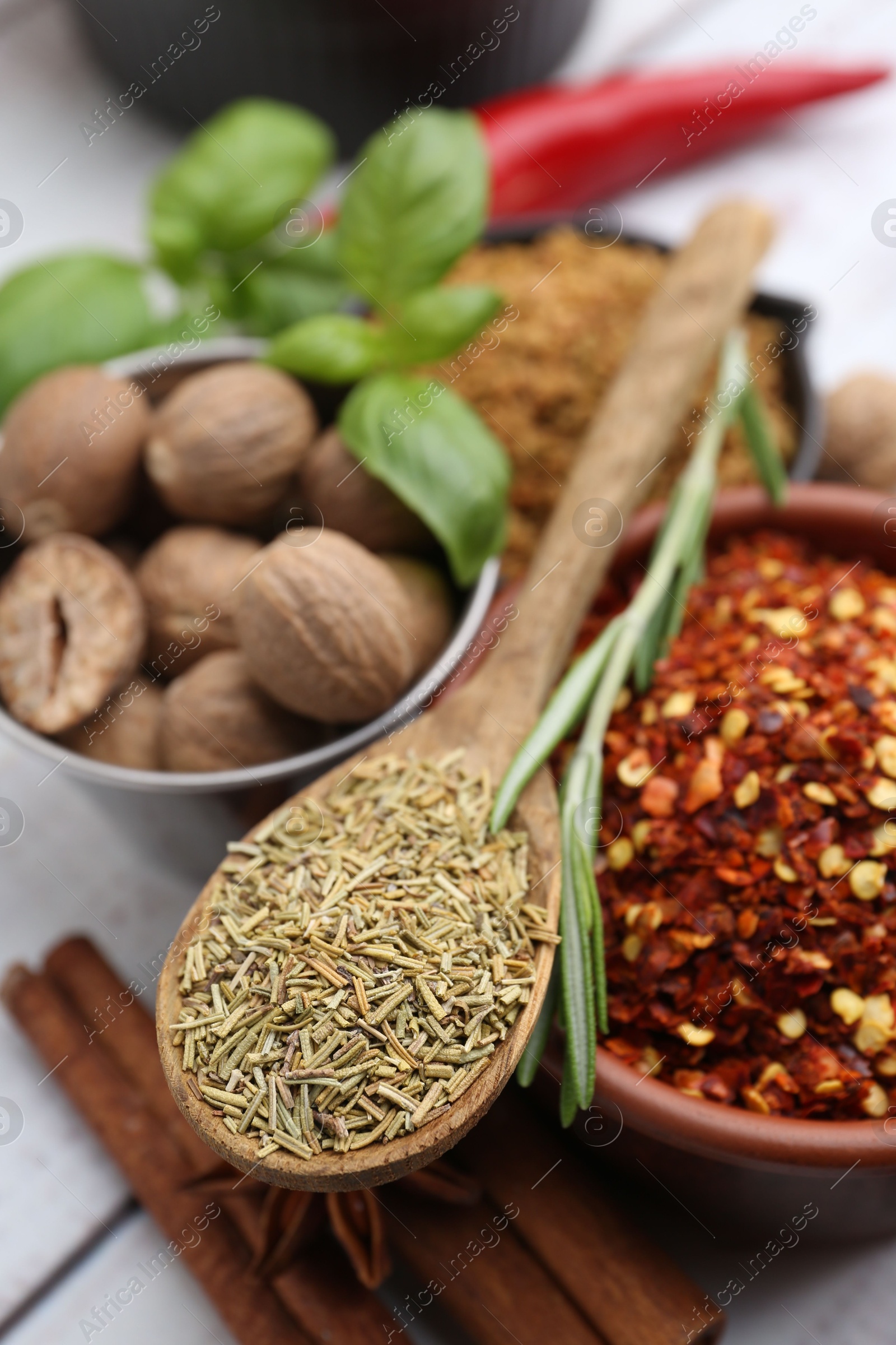 Different aromatic spices on white wooden table, closeup Photo of Different aromatic spices on white wooden table, closeup