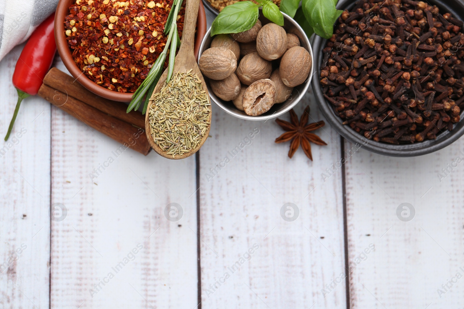 Different aromatic spices on white wooden table, flat lay. Space for text Photo of Different aromatic spices on white wooden table, flat lay. Space for text