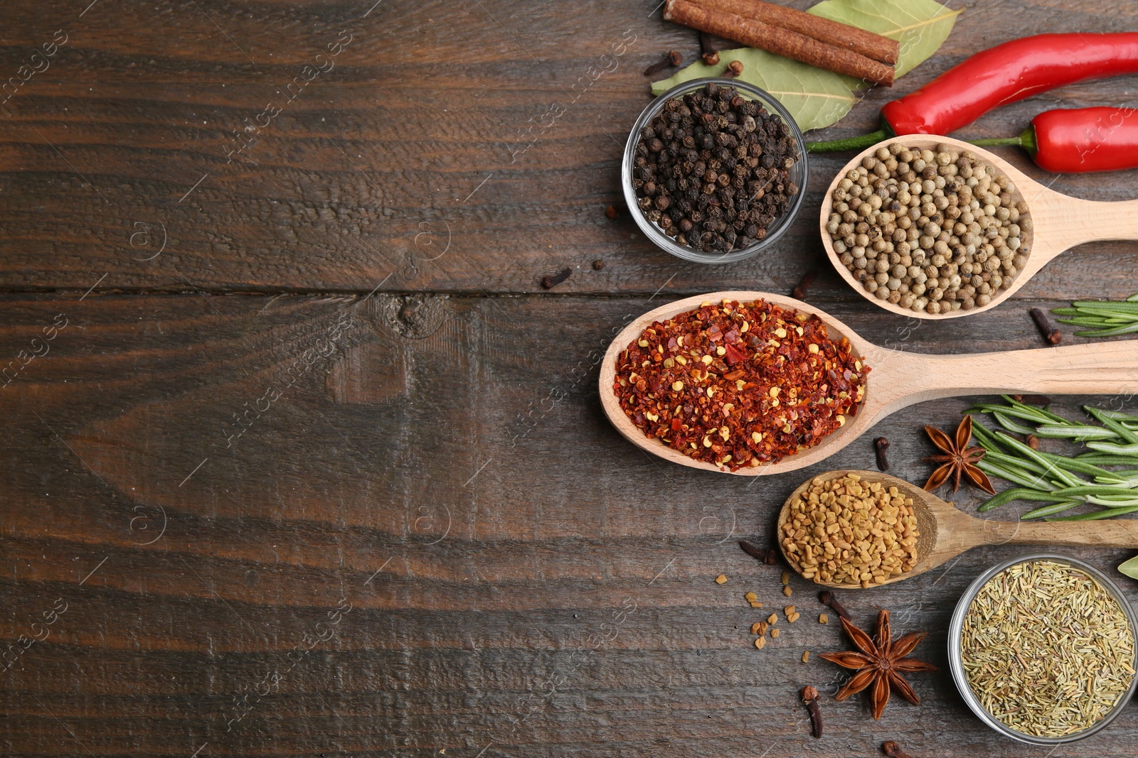 Different aromatic spices on wooden table, flat lay. Space for text Photo of Different aromatic spices on wooden table, flat lay. Space for text
