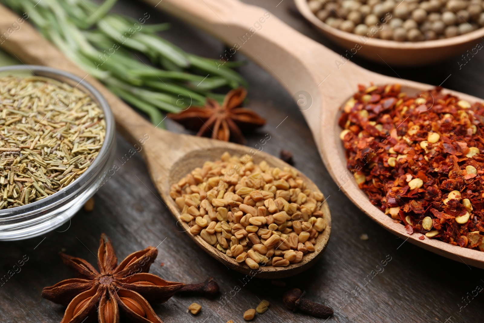 Different aromatic spices on wooden table, closeup Photo of Different aromatic spices on wooden table, closeup
