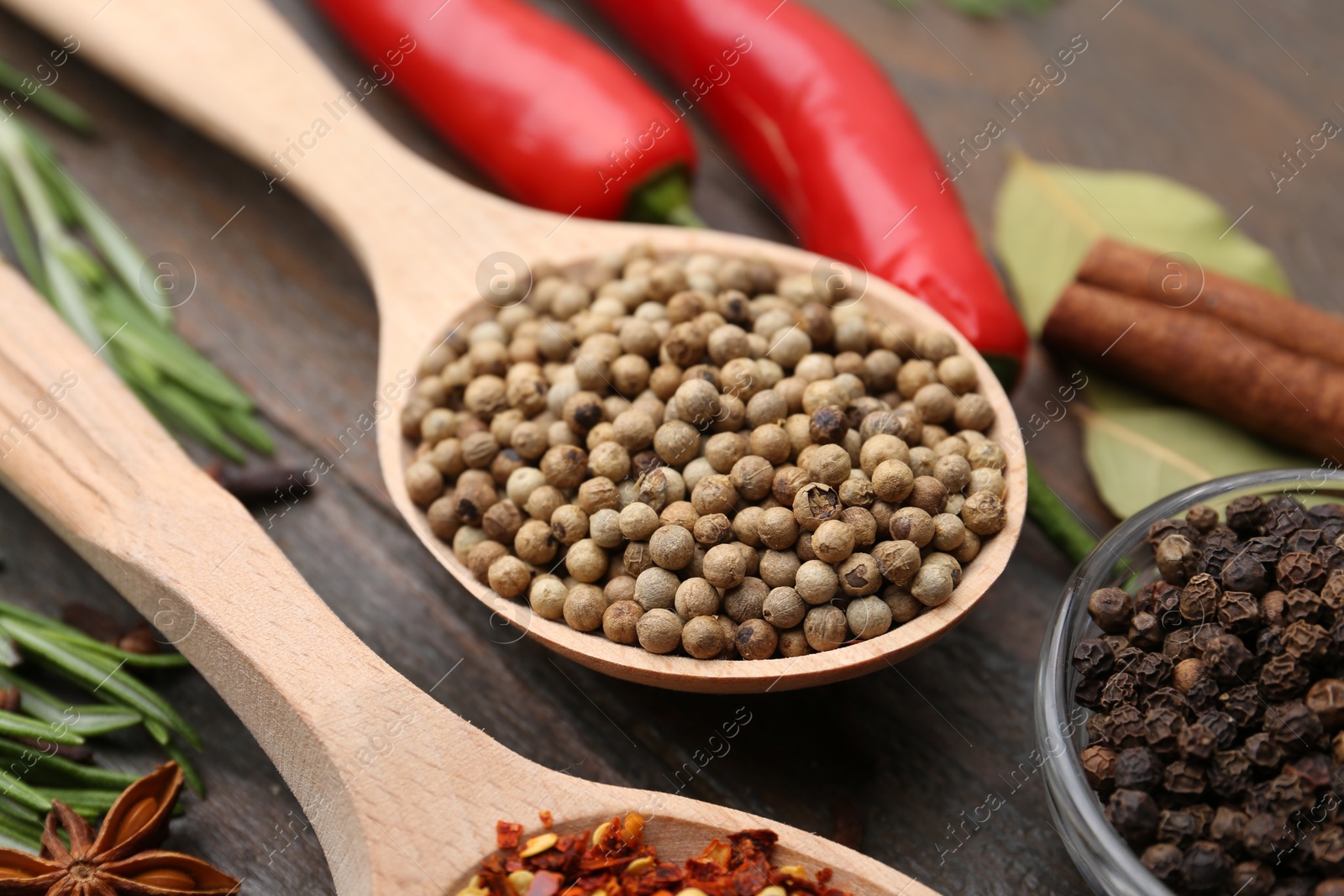 Different aromatic spices on wooden table, closeup Photo of Different aromatic spices on wooden table, closeup