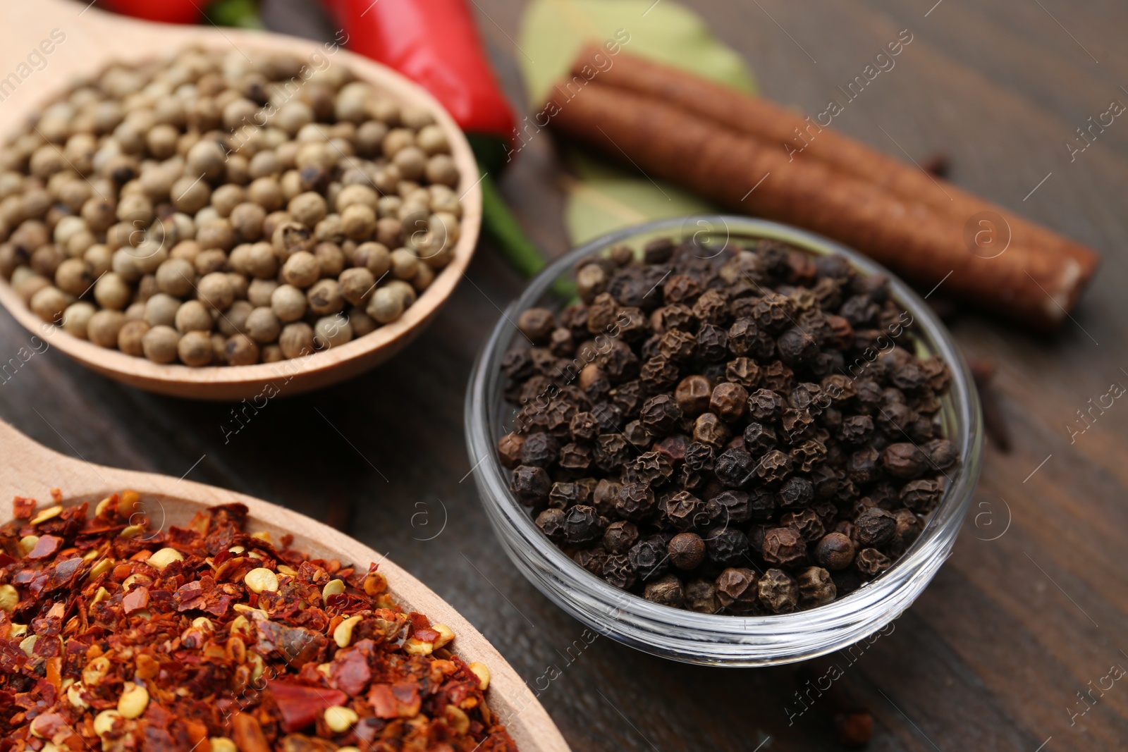 Different aromatic spices on wooden table, closeup Photo of Different aromatic spices on wooden table, closeup