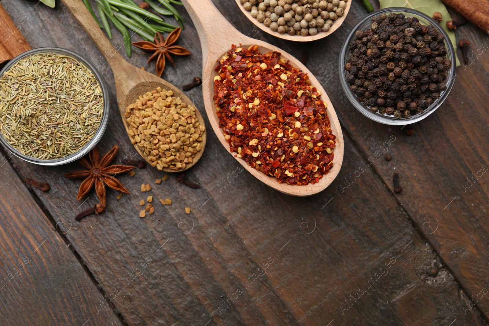 Different aromatic spices on wooden table, flat lay. Space for text Photo of Different aromatic spices on wooden table, flat lay. Space for text
