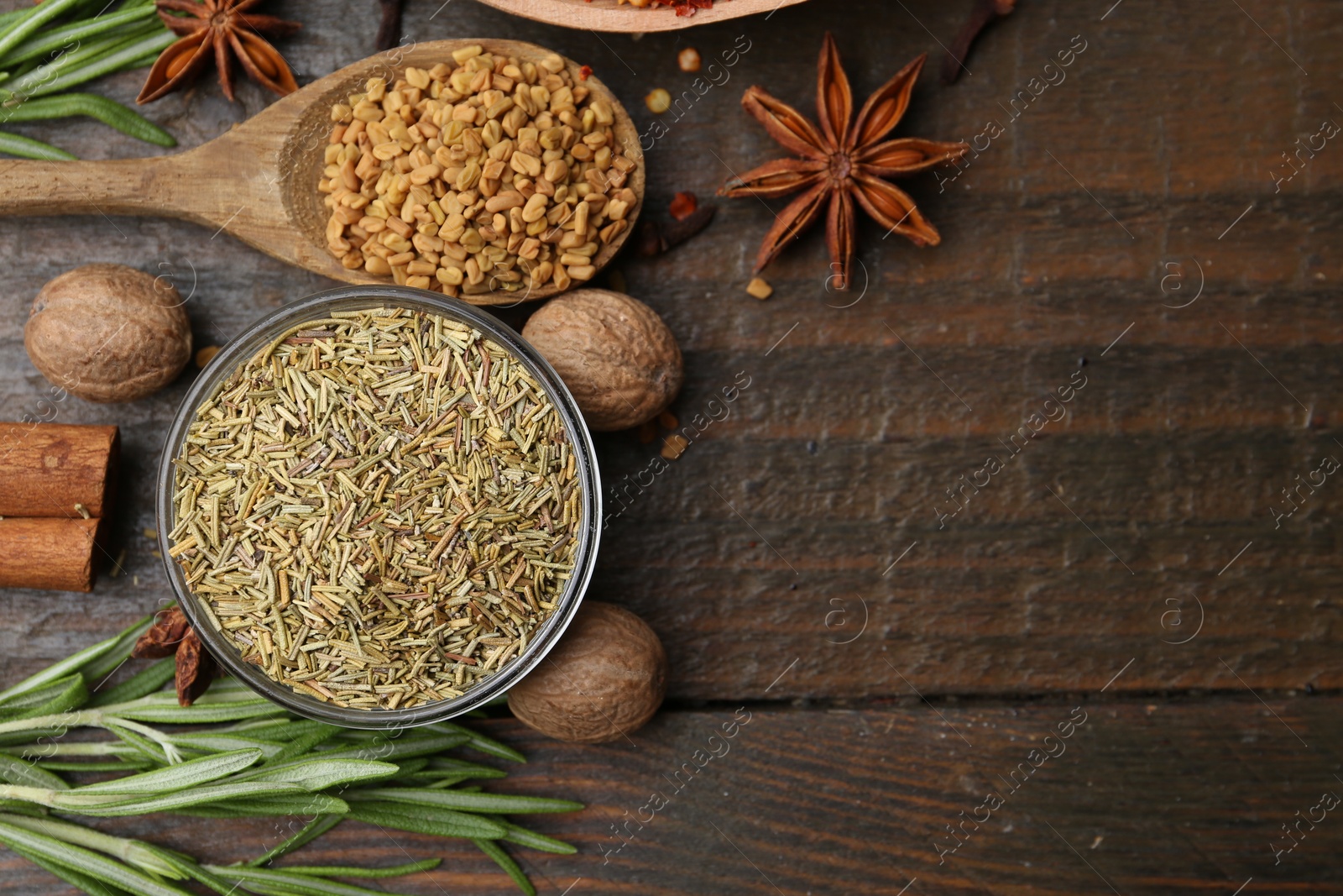 Different aromatic spices on wooden table, flat lay. Space for text Photo of Different aromatic spices on wooden table, flat lay. Space for text