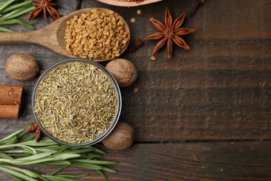 Photo of Different aromatic spices on wooden table, flat lay. Space for text