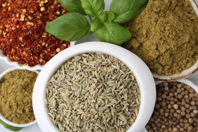 Photo of Different aromatic spices on white table, closeup