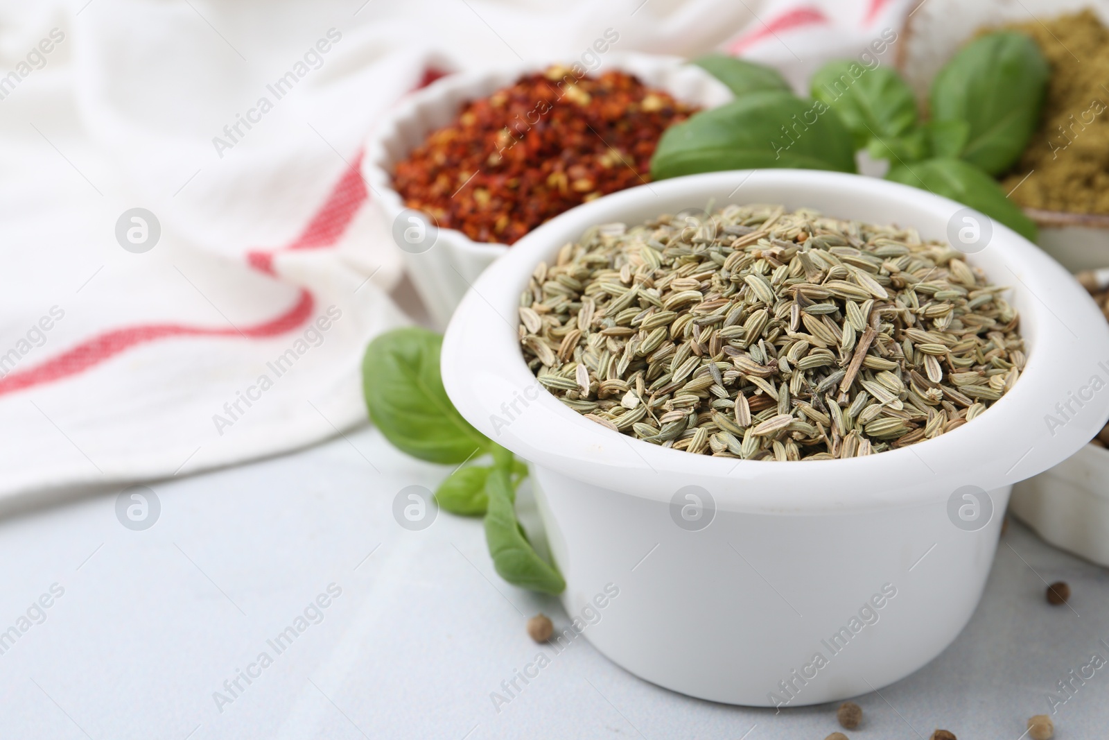 Different aromatic spices on white tiled table, closeup Photo of Different aromatic spices on white tiled table, closeup