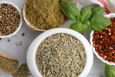 Photo of Different aromatic spices on white table, closeup