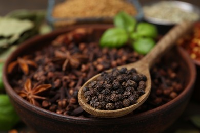 Photo of Different aromatic spices on table, selective focus