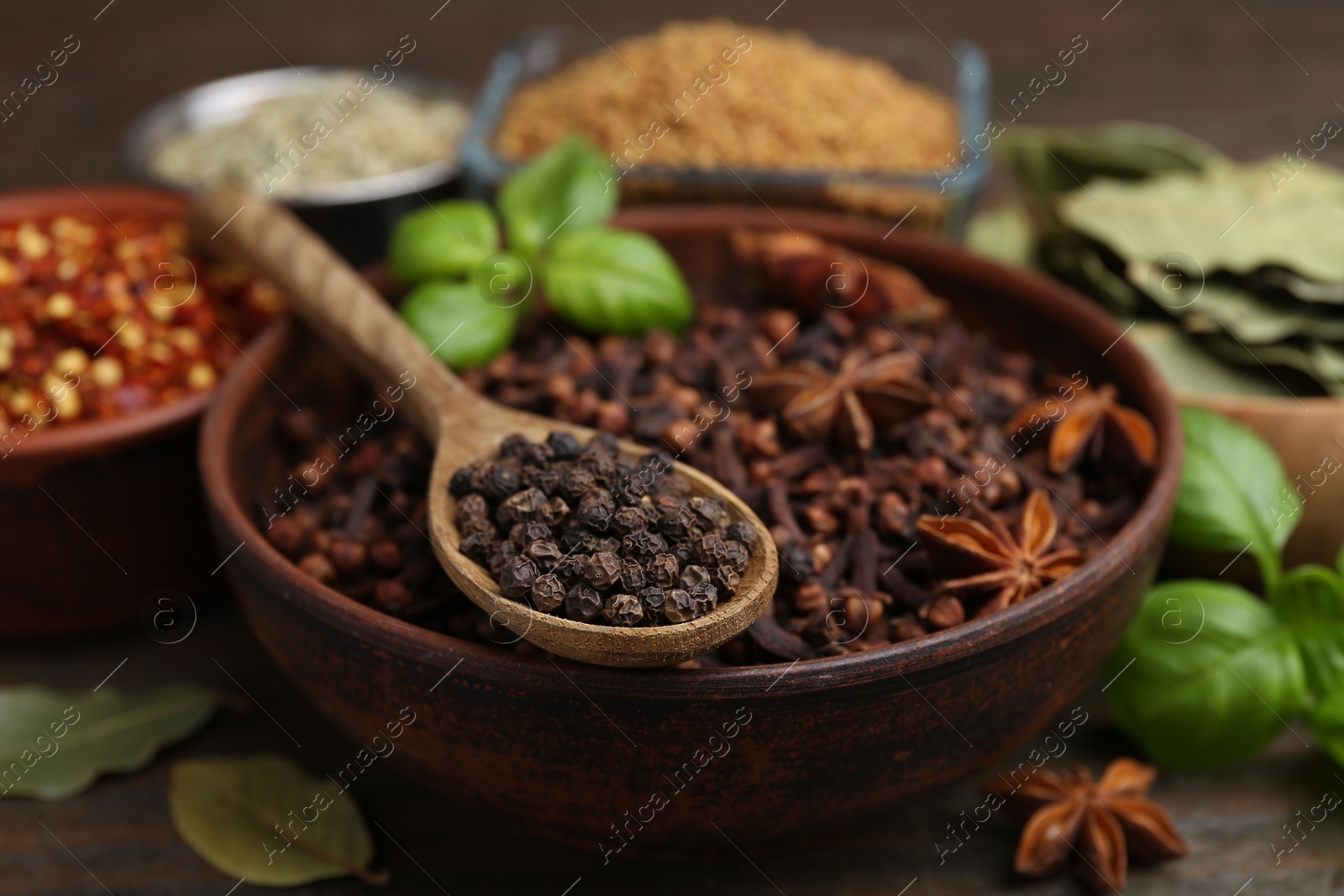 Different aromatic spices on wooden table, closeup Photo of Different aromatic spices on wooden table, closeup