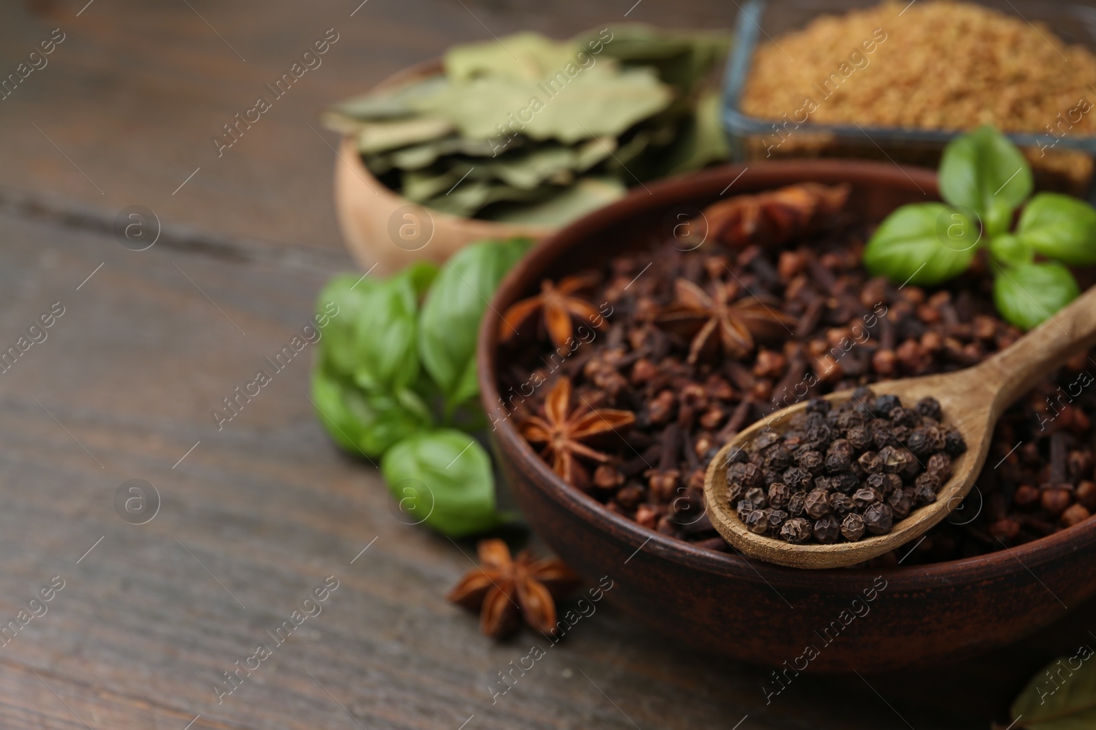 Different aromatic spices on wooden table, closeup. Space for text Photo of Different aromatic spices on wooden table, closeup. Space for text