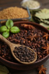 Photo of Different aromatic spices on wooden table, closeup