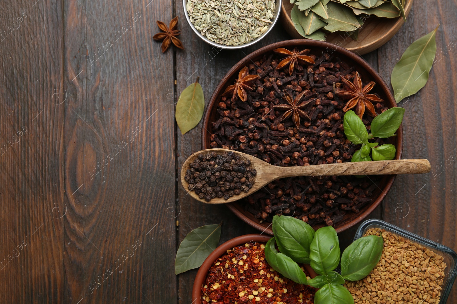 Different aromatic spices on wooden table, flat lay. Space for text Photo of Different aromatic spices on wooden table, flat lay. Space for text