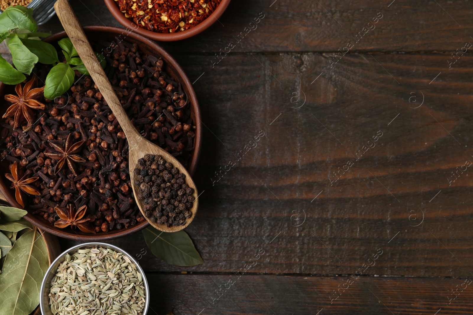 Different aromatic spices on wooden table, flat lay. Space for text Photo of Different aromatic spices on wooden table, flat lay. Space for text