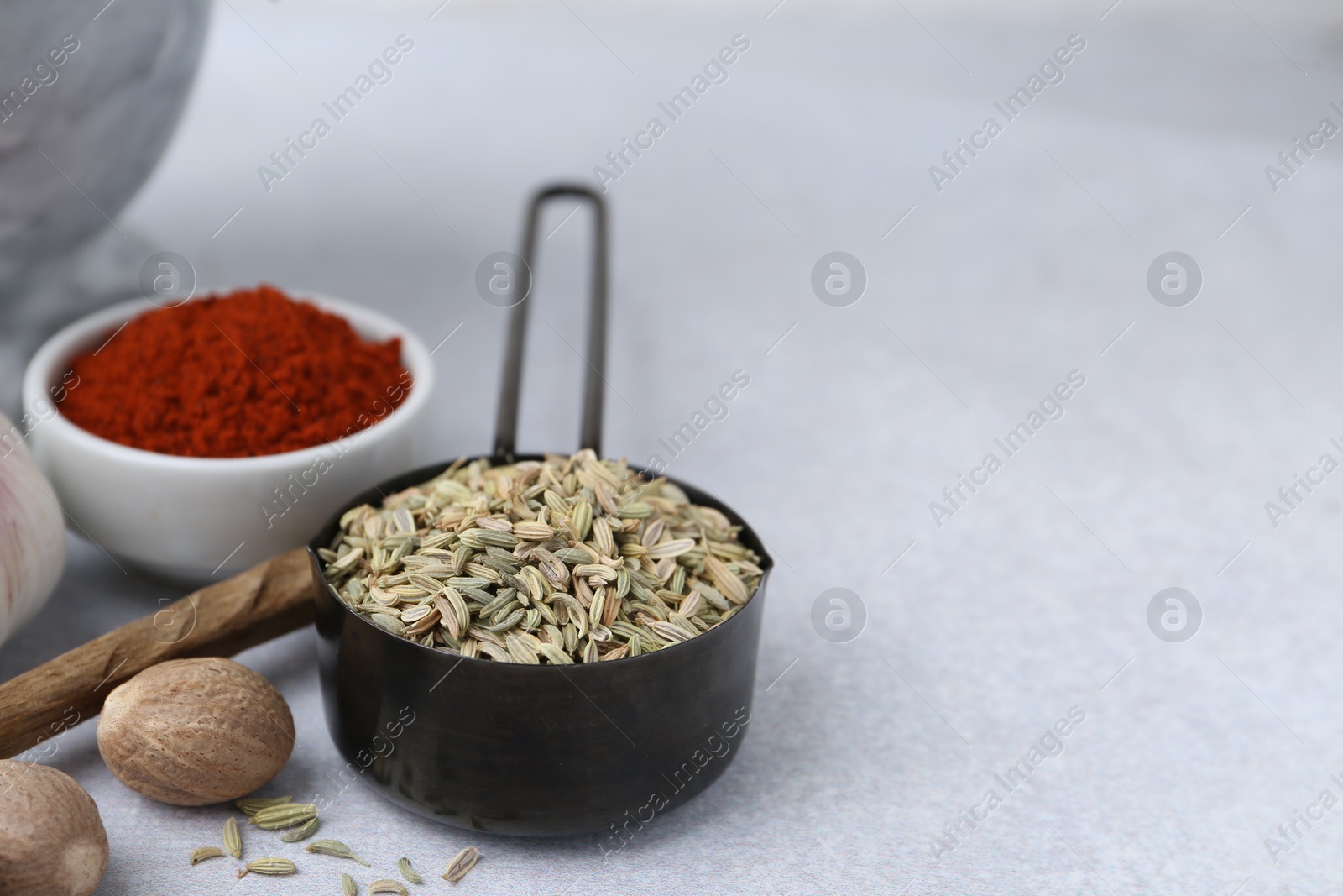 Different aromatic spices on light grey table, closeup. Space for text Photo of Different aromatic spices on light grey table, closeup. Space for text