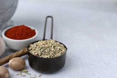 Photo of Different aromatic spices on light grey table, closeup. Space for text