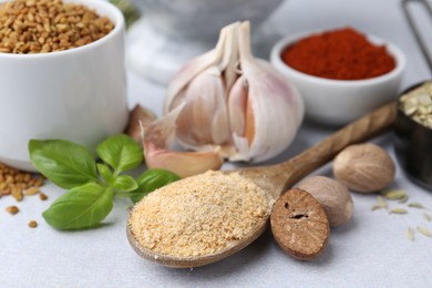 Photo of Different aromatic spices on light grey table, closeup