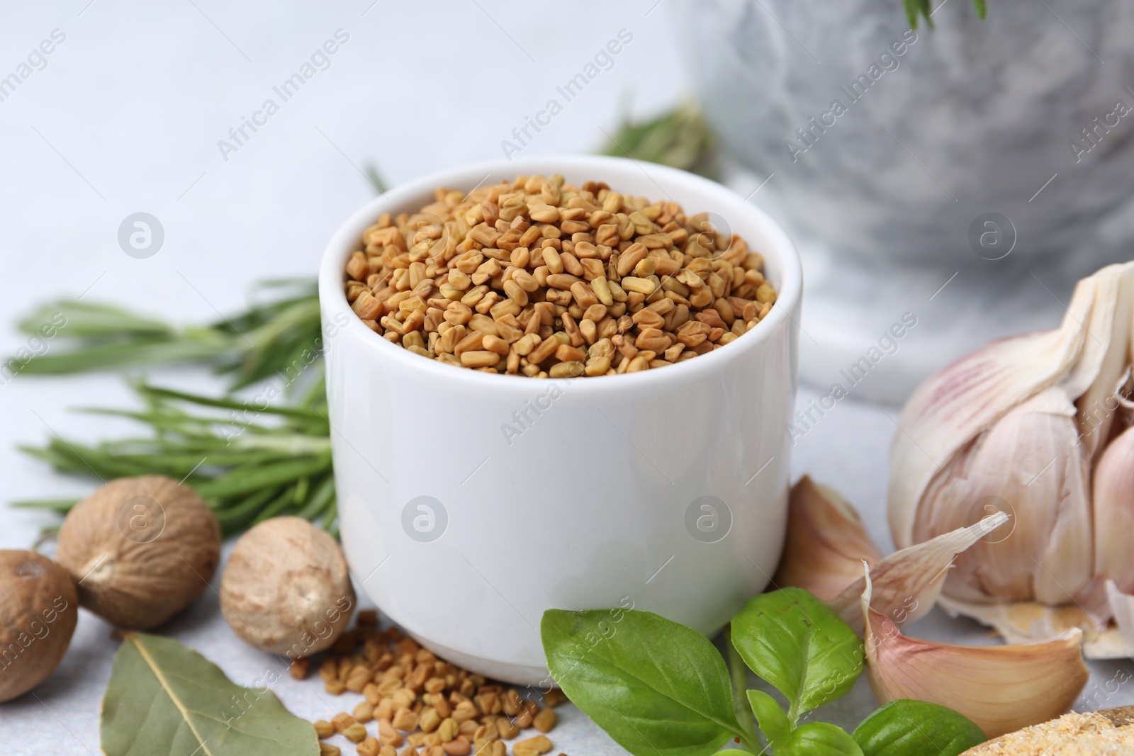 Different aromatic spices on light grey table, closeup Photo of Different aromatic spices on light grey table, closeup