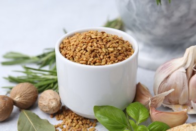 Photo of Different aromatic spices on light grey table, closeup