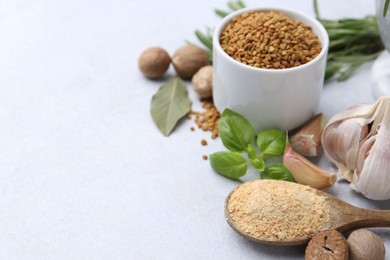 Photo of Different aromatic spices on light grey table, closeup. Space for text