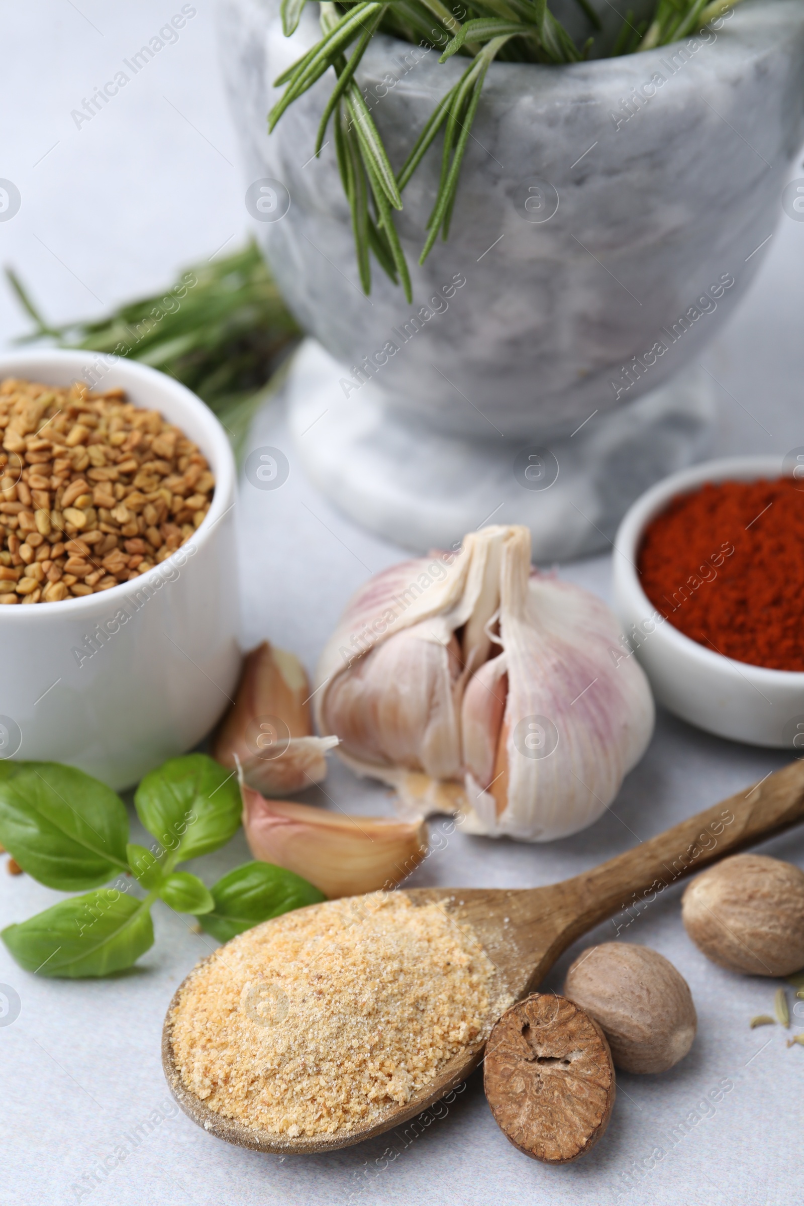 Different aromatic spices on light grey table Photo of Different aromatic spices on light grey table
