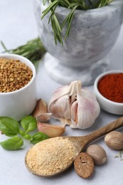 Photo of Different aromatic spices on light grey table