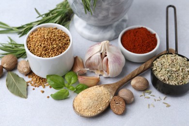Photo of Different aromatic spices on light grey table