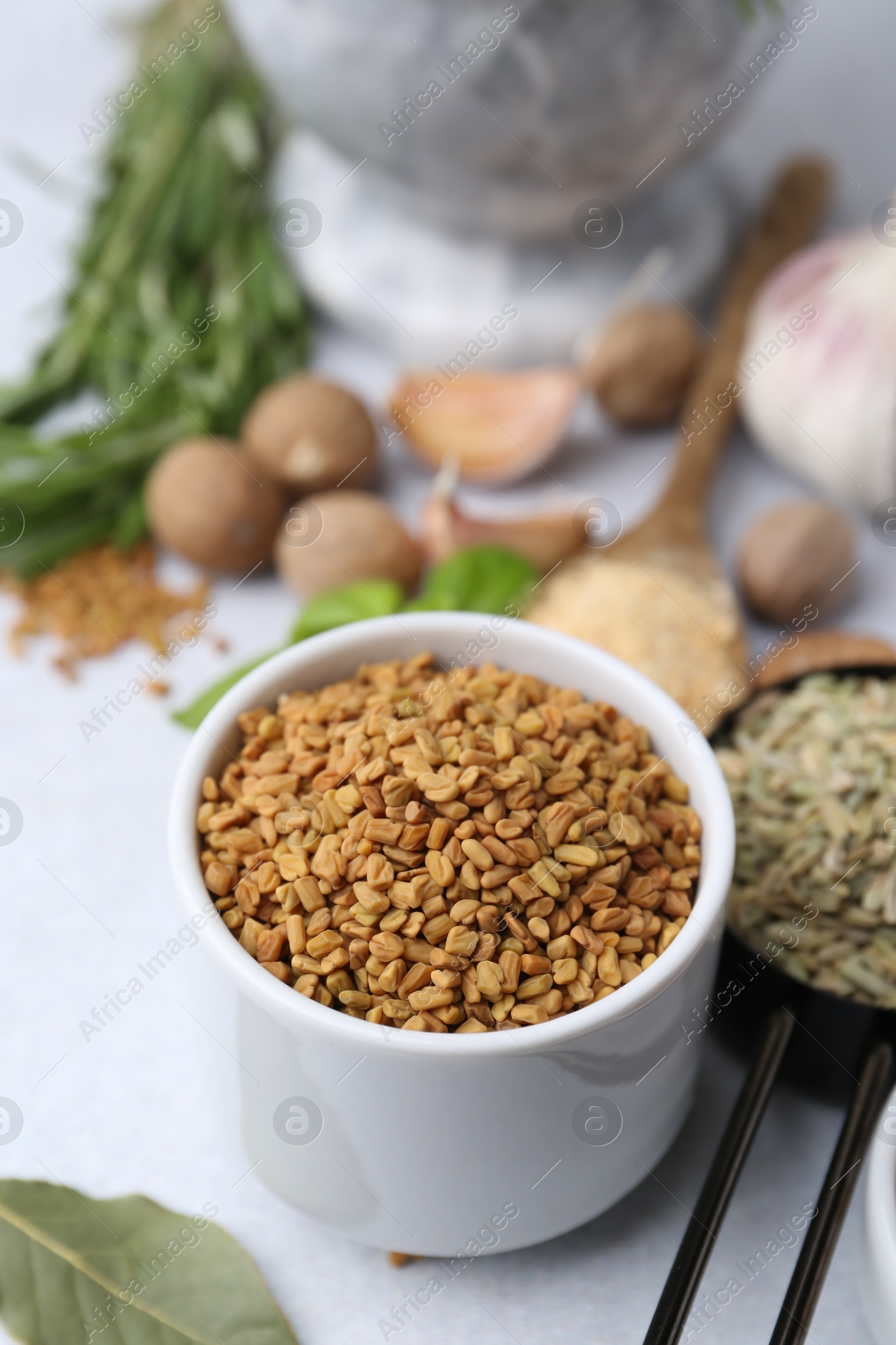 Different aromatic spices on light grey table, selective focus Photo of Different aromatic spices on light grey table, selective focus