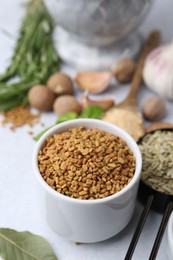 Photo of Different aromatic spices on light grey table, selective focus