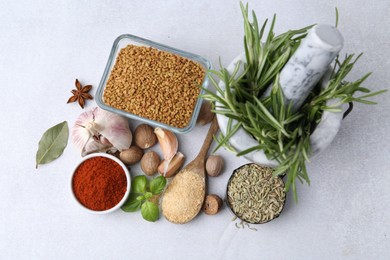 Photo of Different aromatic spices on light grey table, flat lay