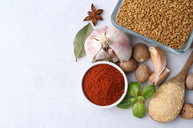 Photo of Different aromatic spices on light grey table, flat lay. Space for text