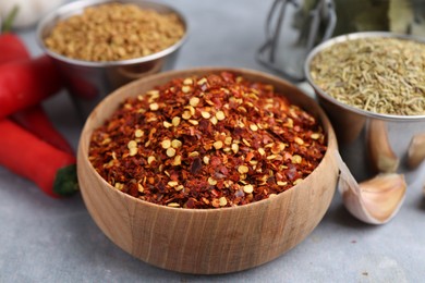 Photo of Different aromatic spices on grey table, closeup