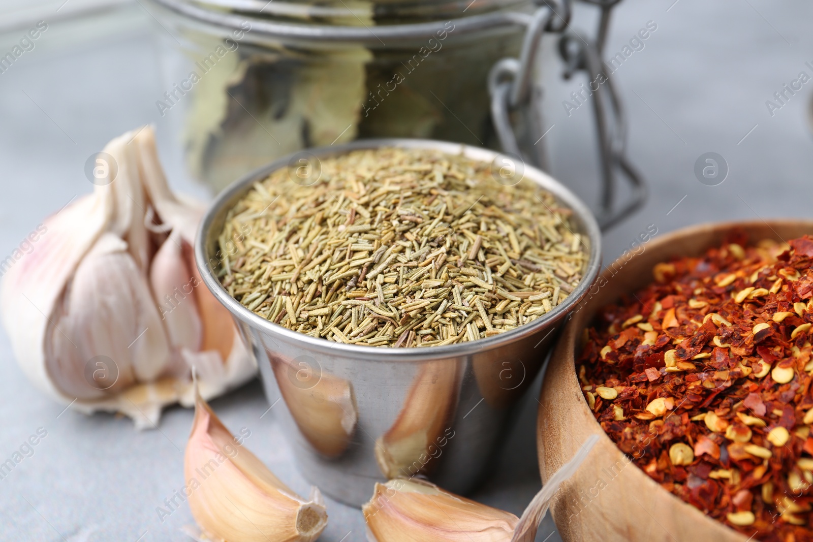 Different aromatic spices on grey table, closeup Photo of Different aromatic spices on grey table, closeup