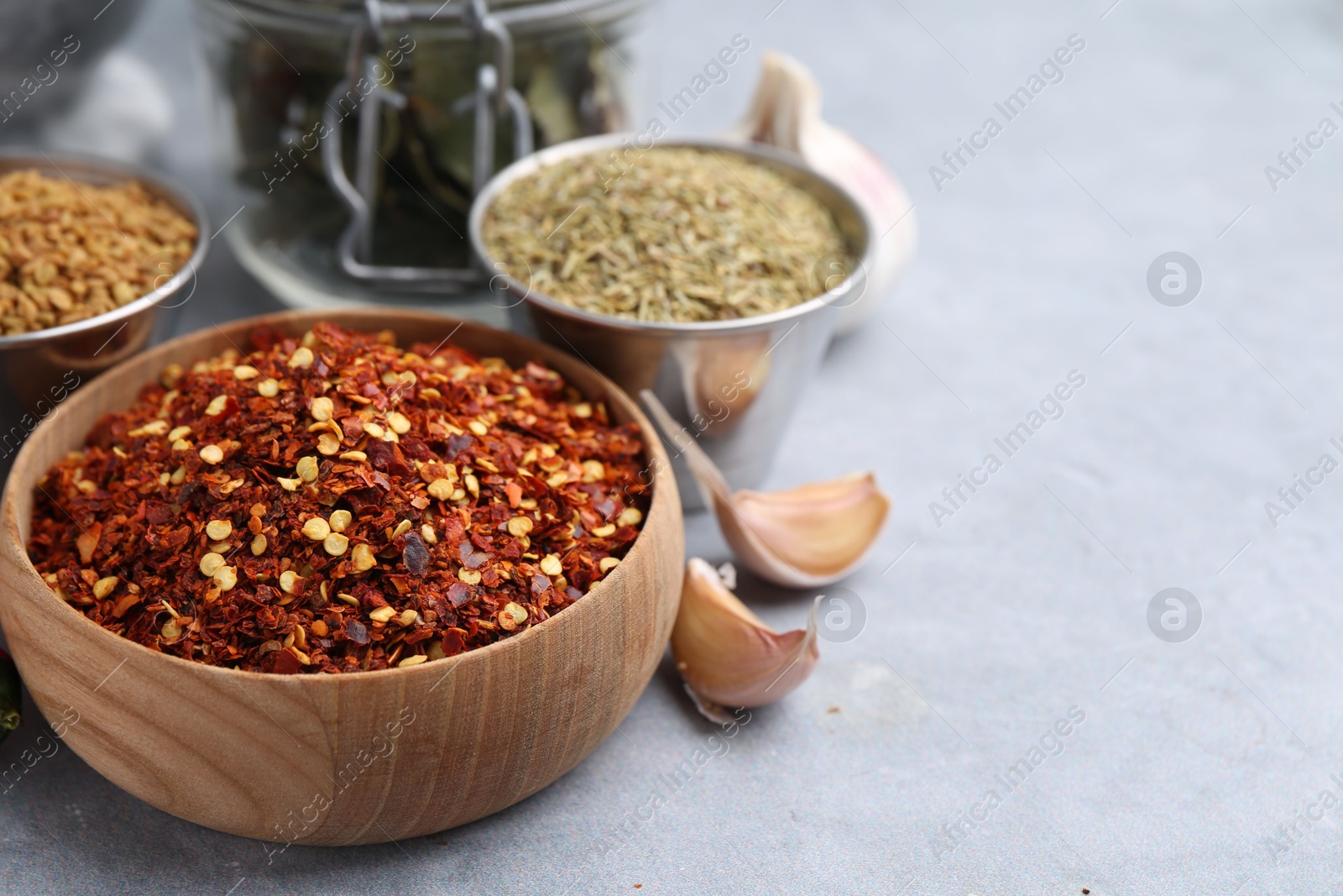 Different aromatic spices on grey table, closeup. Space for text Photo of Different aromatic spices on grey table, closeup. Space for text