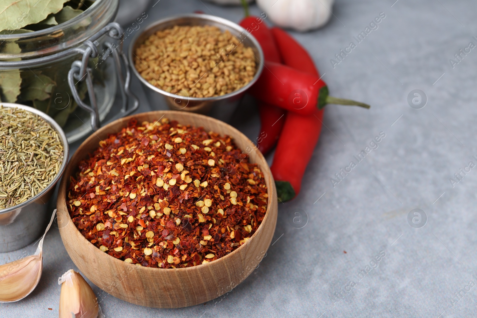 Different aromatic spices on grey table, closeup. Space for text Photo of Different aromatic spices on grey table, closeup. Space for text