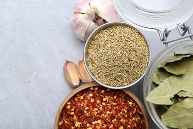 Photo of Different aromatic spices on grey table, flat lay. Space for text