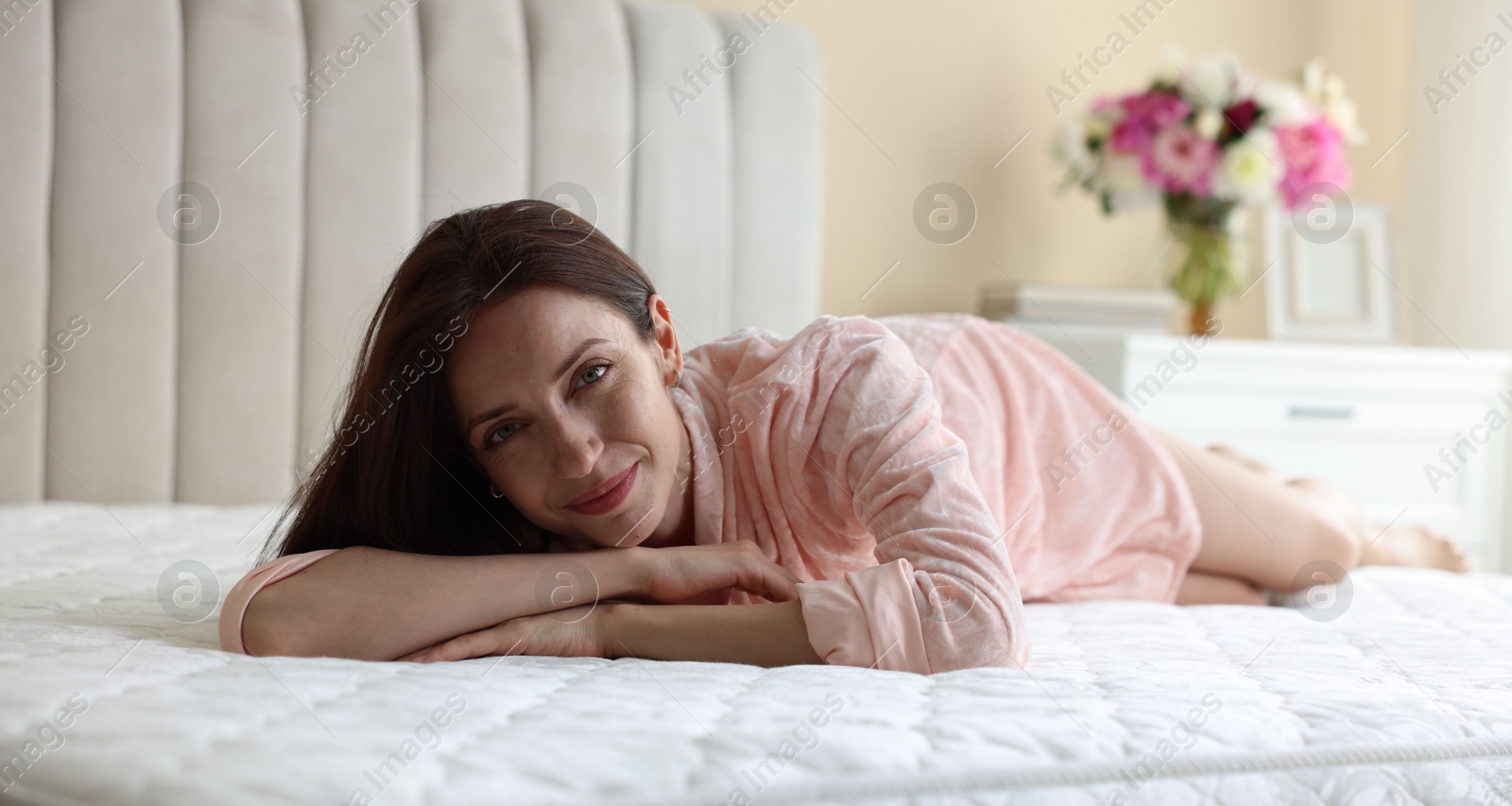 Woman lying on bed with orthopedic mattress at home Photo of Woman lying on bed with orthopedic mattress at home
