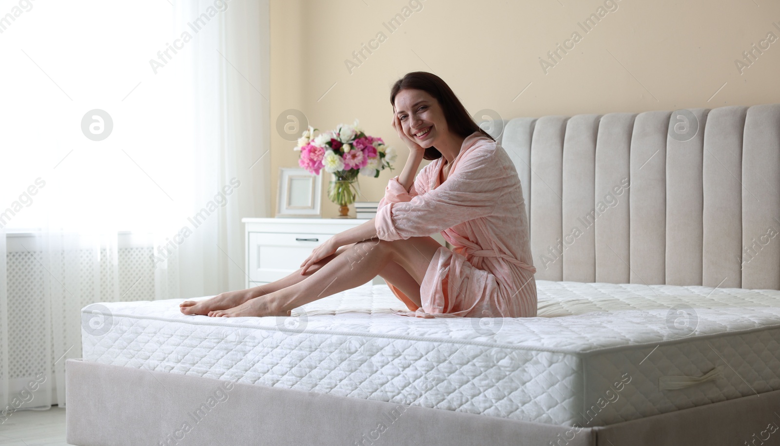 Woman on bed with orthopedic mattress at home Photo of Woman on bed with orthopedic mattress at home