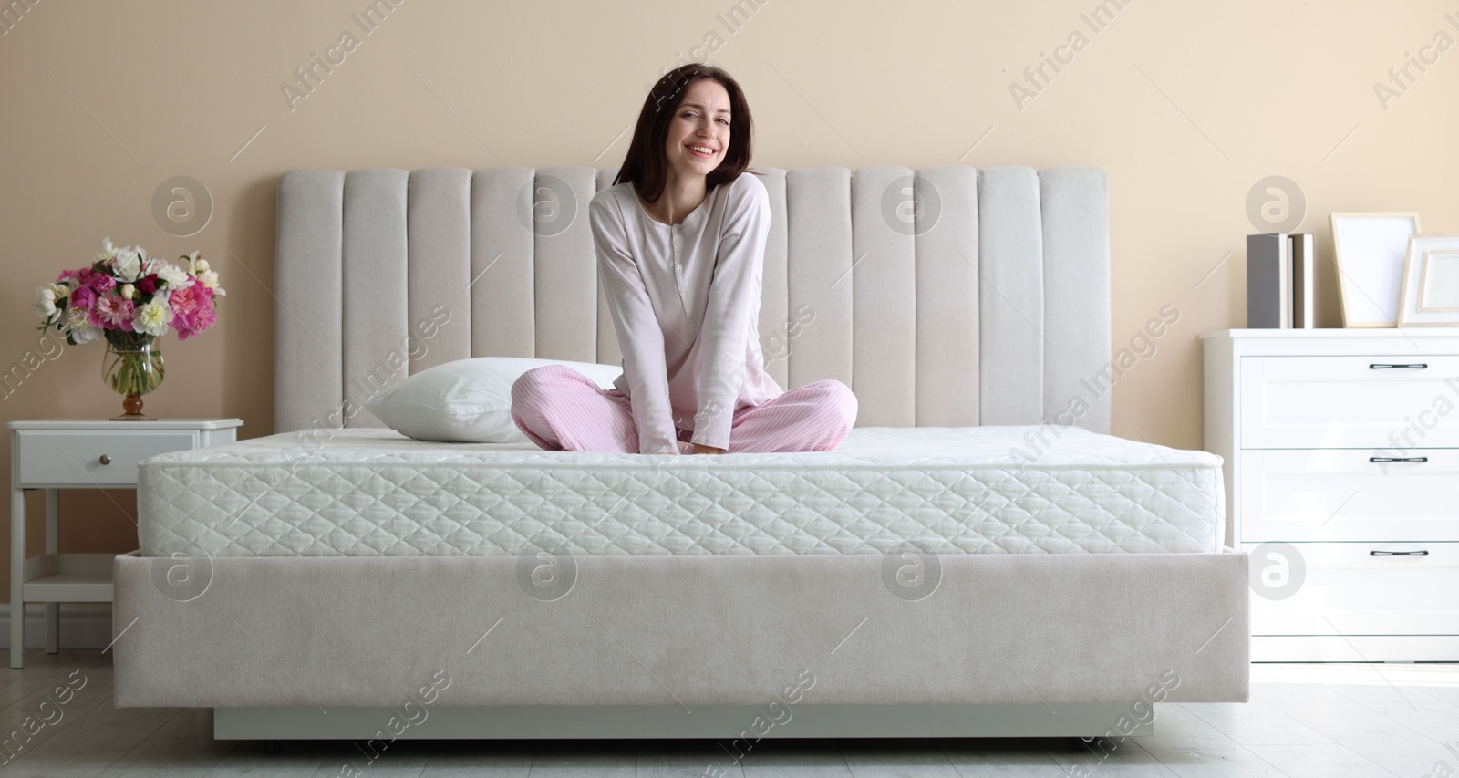 Woman on bed with orthopedic mattress at home Photo of Woman on bed with orthopedic mattress at home
