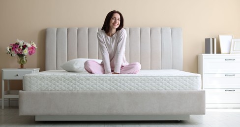 Photo of Woman on bed with orthopedic mattress at home