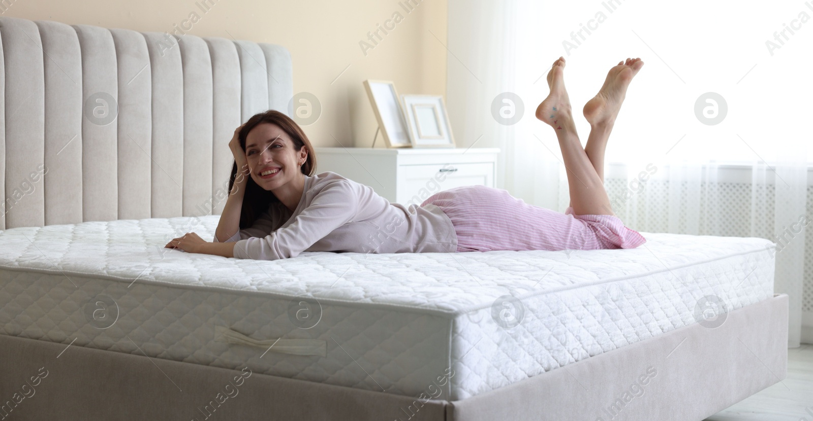 Woman lying on bed with orthopedic mattress at home Photo of Woman lying on bed with orthopedic mattress at home