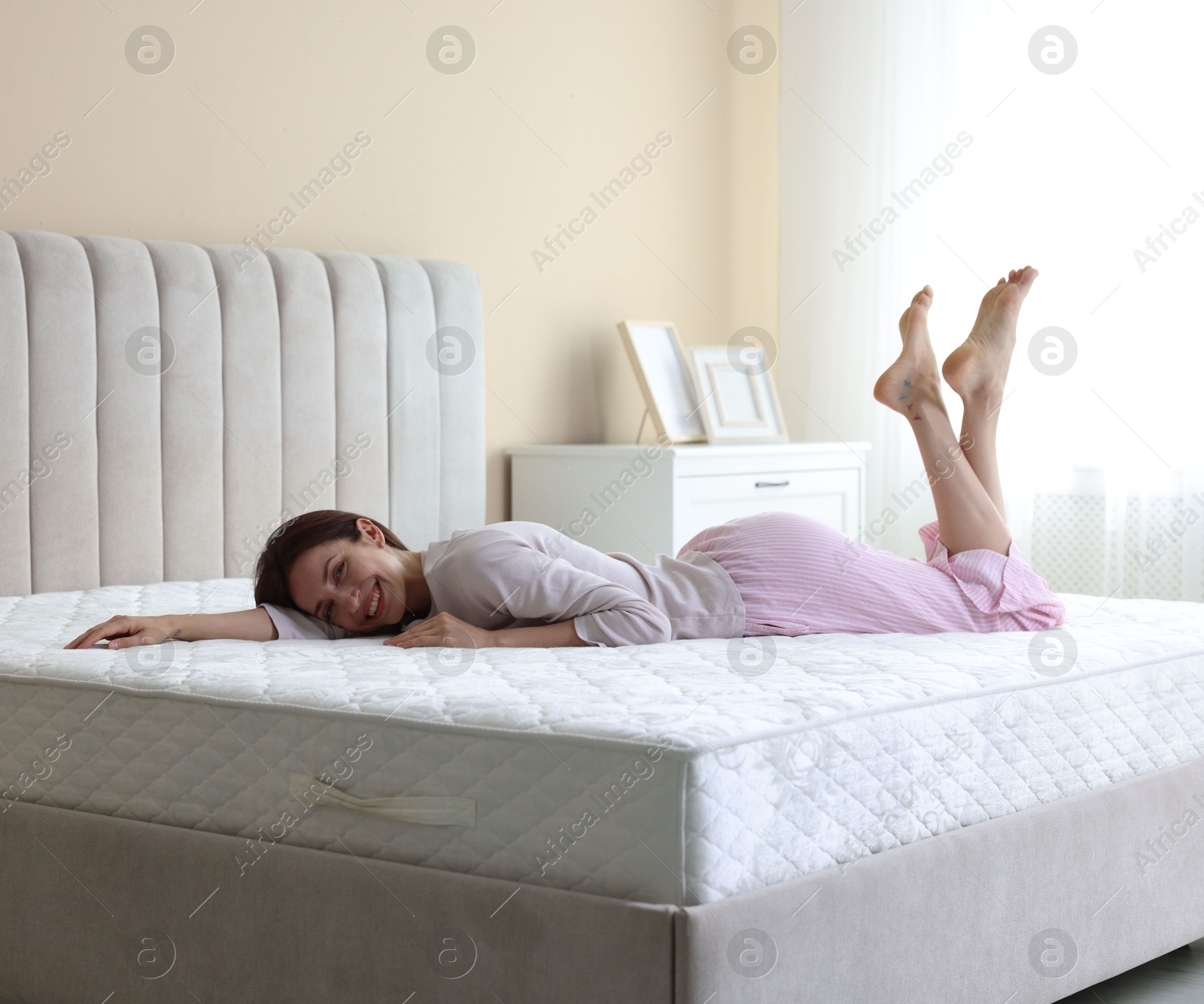 Woman lying on bed with orthopedic mattress at home Photo of Woman lying on bed with orthopedic mattress at home