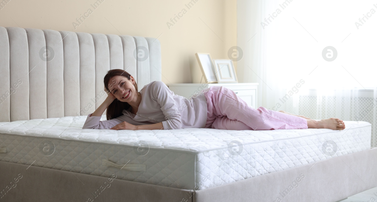 Woman lying on bed with orthopedic mattress at home Photo of Woman lying on bed with orthopedic mattress at home