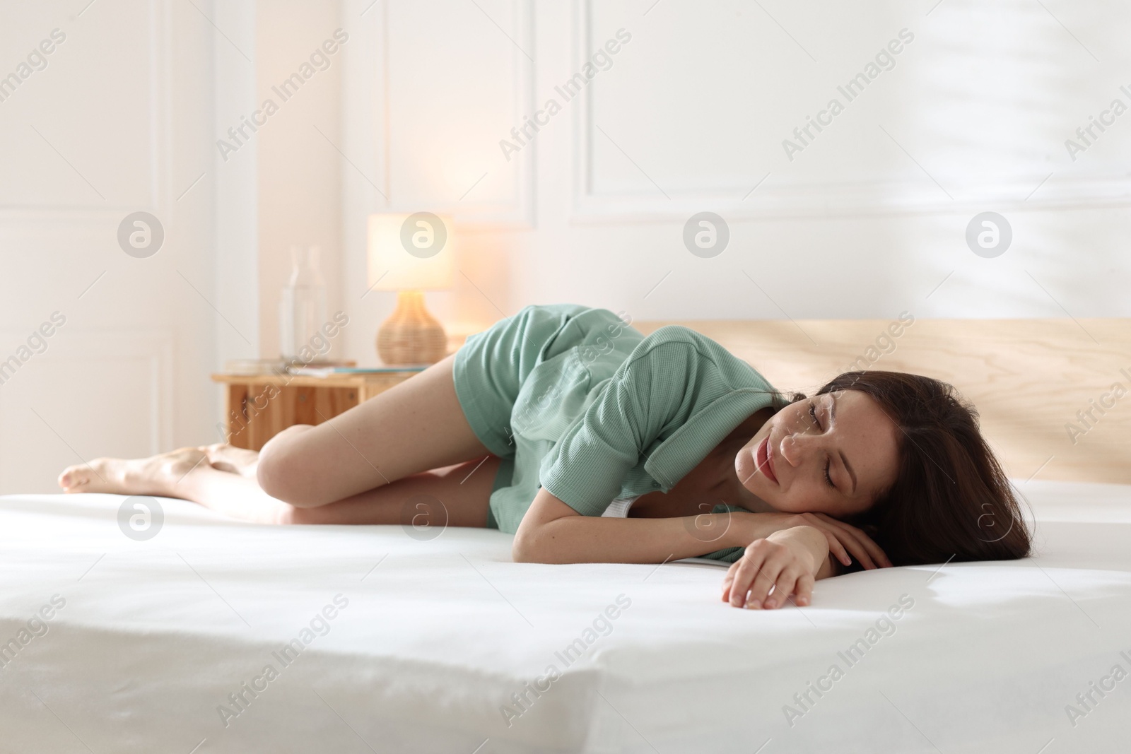 Woman sleeping on bed with orthopedic mattress at home Photo of Woman sleeping on bed with orthopedic mattress at home